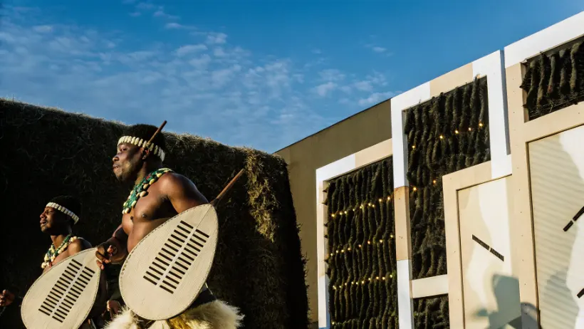 Traditional Zulu cultural dance performance with modern digital elements